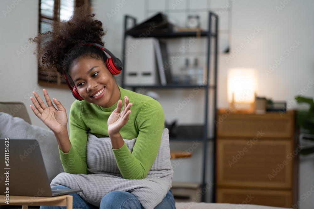 Happy african american woman having video call with her family. Happy african american woman having video call with her family.
