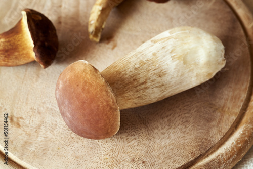 Fresh porcini or king bolete mushroom on a wooden cutting board