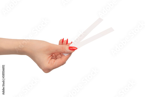 Photos Woman hand with red nails with test strips for the perfume, isolated on a white background