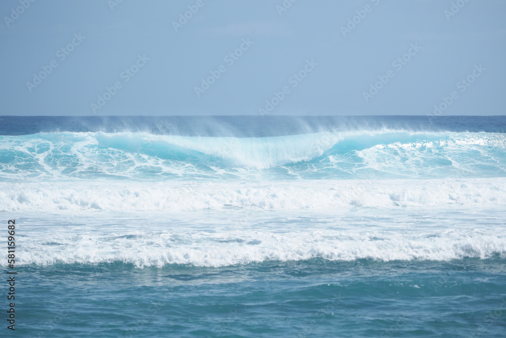 Big powerful turquoise ocean wave crashing. Surf spot.