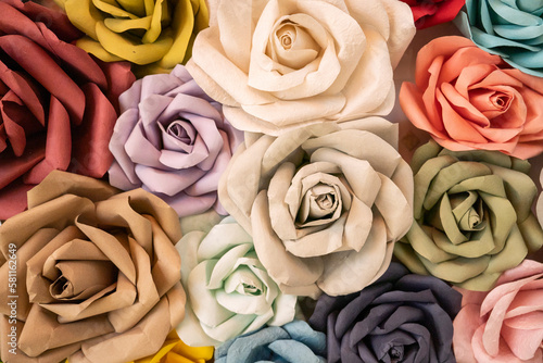 Roses made of vintage colorful paper adorn the wall.