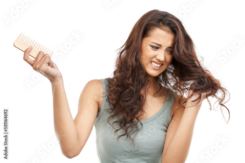 Hair problems. A woman struggling with her hair holding a comb.