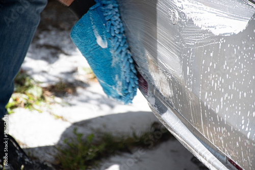Washing  a  Silver  car  with  pressure  washer  and  cloth 