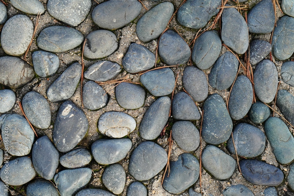 Top view of gray stones next to each other on the ground, perfect as a background Top view of gray stones next to each other on the ground, perfect as a background