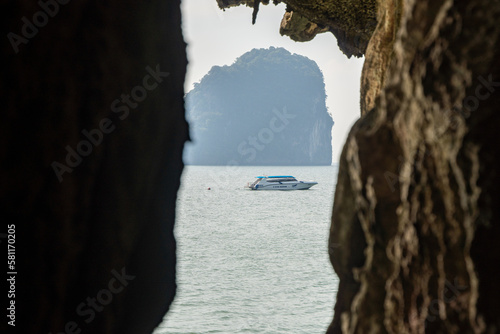Boat between the rocks on the background of the islands