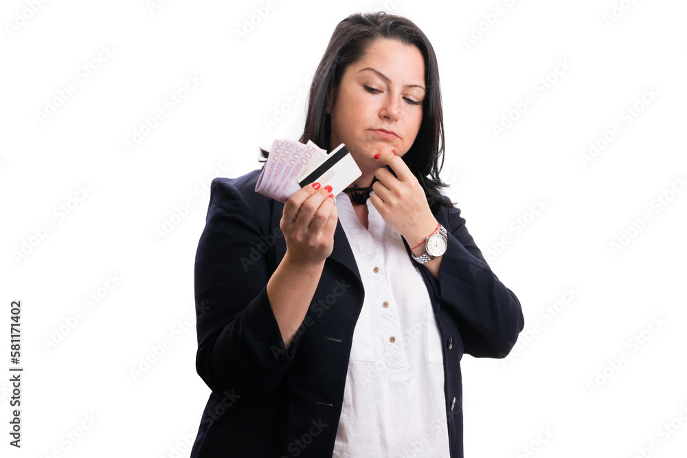 Businesswoman looking at cash money and card thinking Businesswoman looking at cash money and card thinking