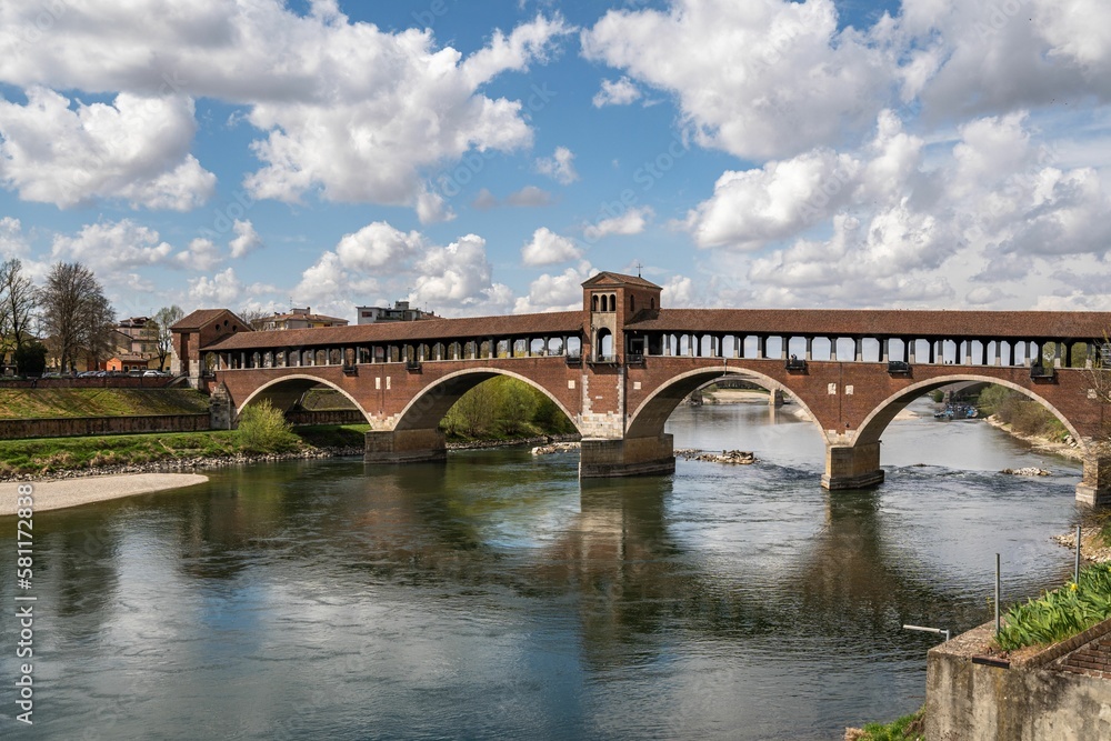 Beautiful shot of the historic Ponte Coperto Bridge over the Ticino river in Pavia, Lombardy, Italy