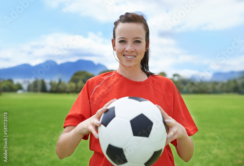 In it to win. a young female soccer player holding a soccer ball. © Hova/peopleimages.com