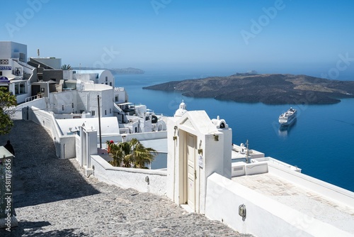 Scenic view of the town of Fira and its beautiful architecture with a cruise ship in the back