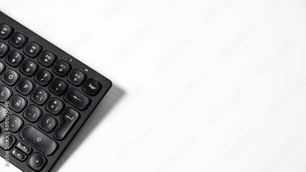 Black keyboard on a white background. Close-up, selective focus. Black keyboard on a white background. Close-up, selective focus.