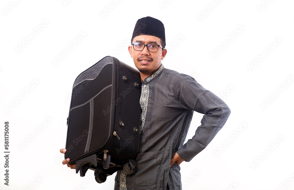 Excited Asian muslim man holding suitcase. Homecoming and ramada Excited Asian muslim man holding suitcase. Homecoming and ramada