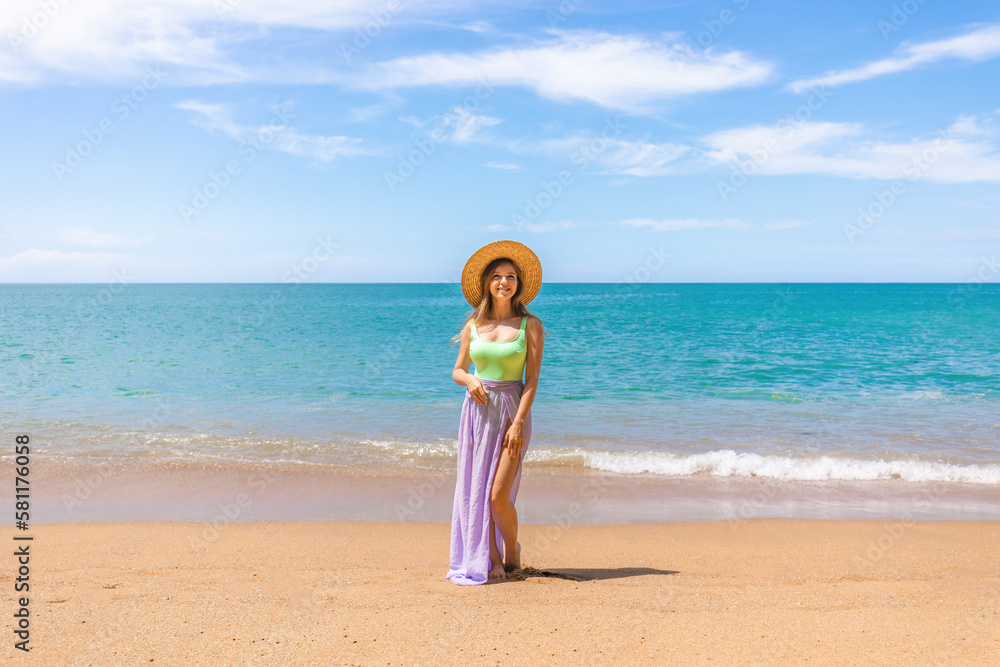 Attractive woman in swimwear on the beach or ocean, relaxes on vacation, calm and serenity of the exotic location. Smiling girl in a straw hat enjoying sunshine and leisurely of tropical getaway Attractive woman in swimwear on the beach or ocean, relaxes on vacation, calm and serenity of the exotic location. Smiling girl in a straw hat enjoying sunshine and leisurely of tropical getaway