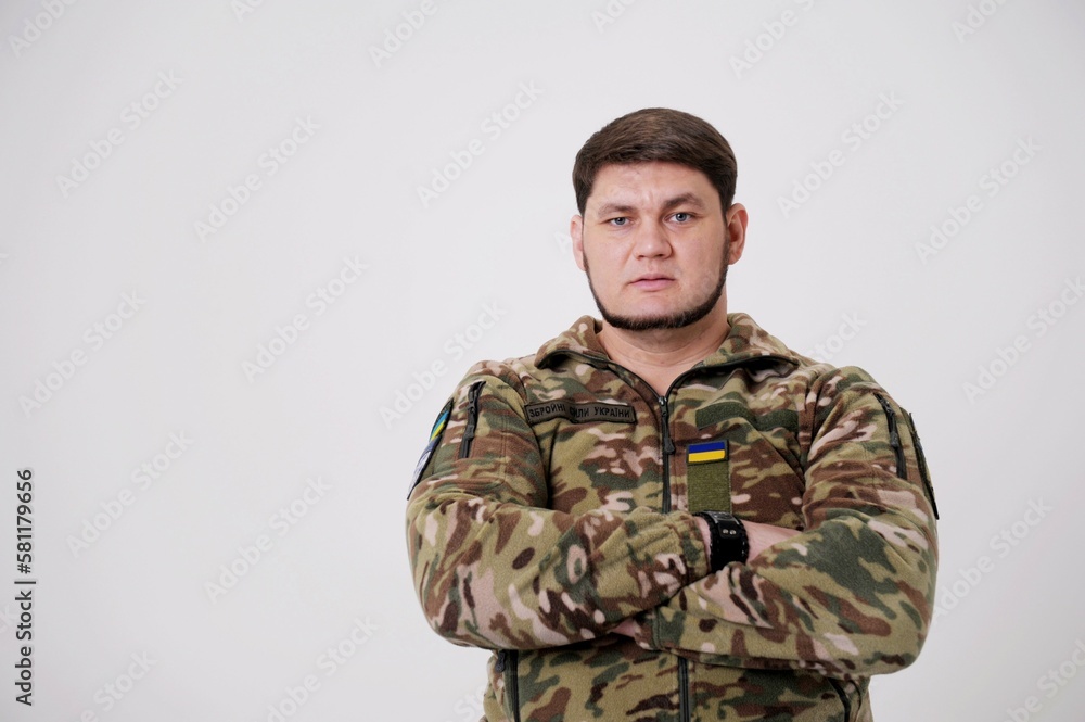 Ukrainian soldier wearing military uniform with flag and chevron depicting trident Ukrainian emblem and national symbol Midsection Of Army Soldier Standing Armed Forces of Ukraine. Ukrainian soldier Ukrainian soldier wearing military uniform with flag and chevron depicting trident Ukrainian emblem and national symbol Midsection Of Army Soldier Standing Armed Forces of Ukraine. Ukrainian soldier