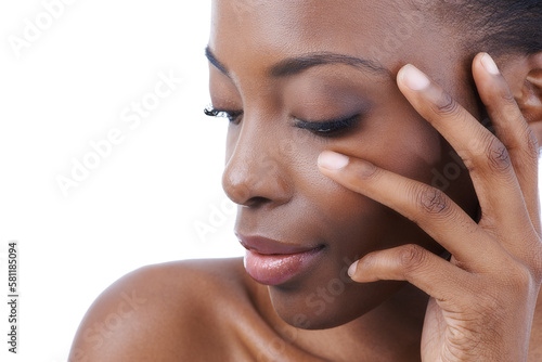 Naturally beautiful. Clloseup studio shot of an african american model touching her face. photo