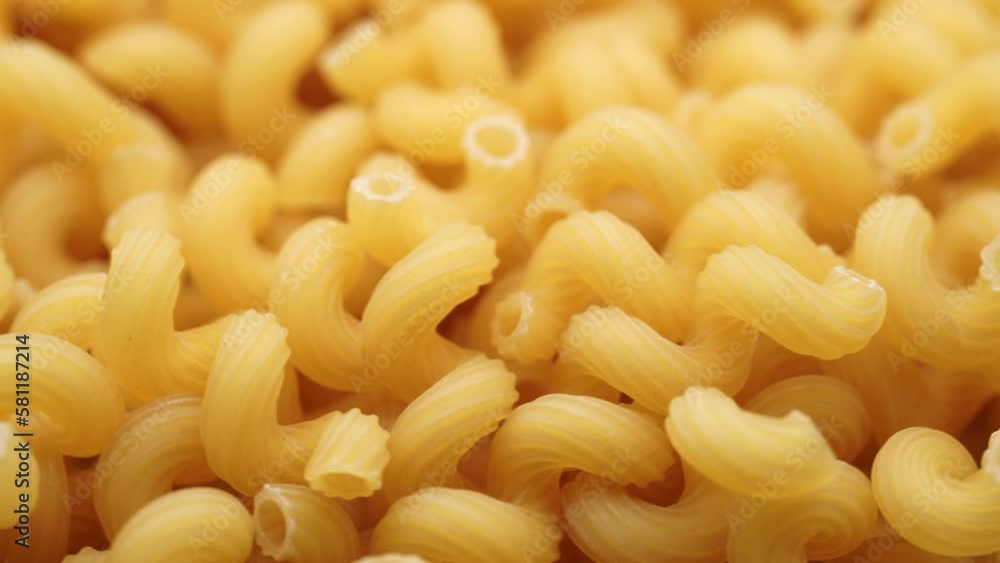 Background of Uncooked Noodles that Slowly Rotating. Texture of Dry Vermicelli Turning Around. Raw Pasta. Bunch of raw pasta spins in a circle Background of Uncooked Noodles that Slowly Rotating. Texture of Dry Vermicelli Turning Around. Raw Pasta. Bunch of raw pasta spins in a circle