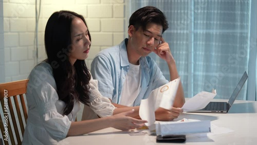 Asian couple is in debt and unable to pay the bills.