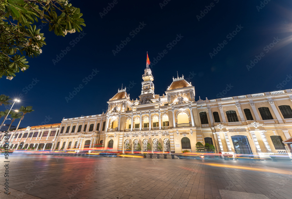 Traffic in front of Ho Chi Minh City Hall, Saigon City Hall or Committee Head office in the evening, Vietnam. Light trail and night. Popular place to visit in Saigon