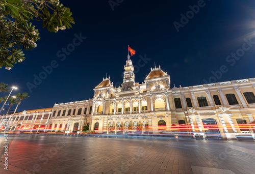 Traffic in front of Ho Chi Minh City Hall, Saigon City Hall or Committee Head office in the evening, Vietnam. Light trail and night. Popular place to visit in Saigon photo