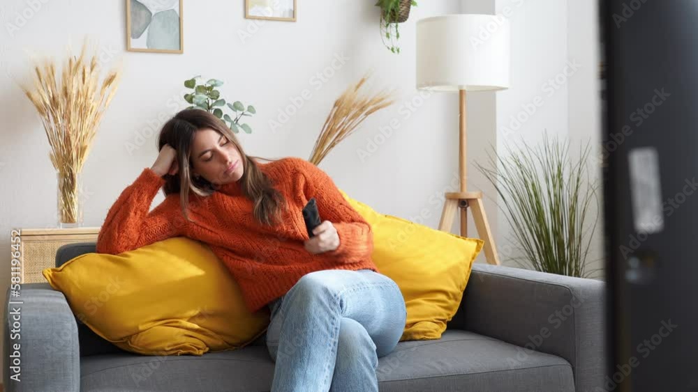 bored Young woman watching tv in living room bored Young woman watching tv in living room
