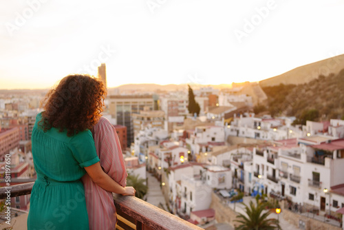 two lesbian girls in love watch the sunset on gay pride day