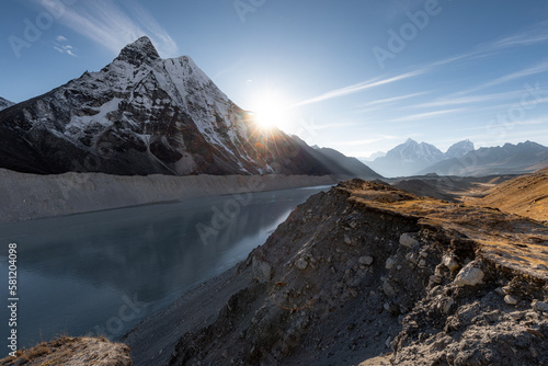 Sunset over Imja Lake at the Island Peak base camp. After sunset you get a bit of a rest and shortly after midnight you start climb up to the peak at the altitude of 6189m. photo