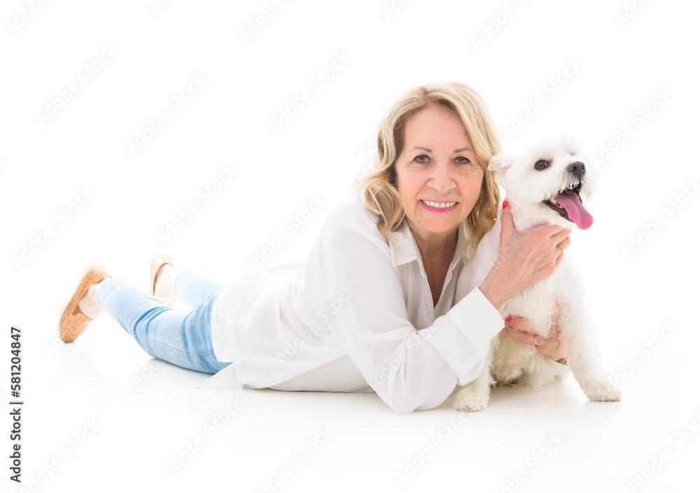 Cheerful retired senior woman with dog and enjoying time with pet on studio white Cheerful retired senior woman with dog and enjoying time with pet on studio white