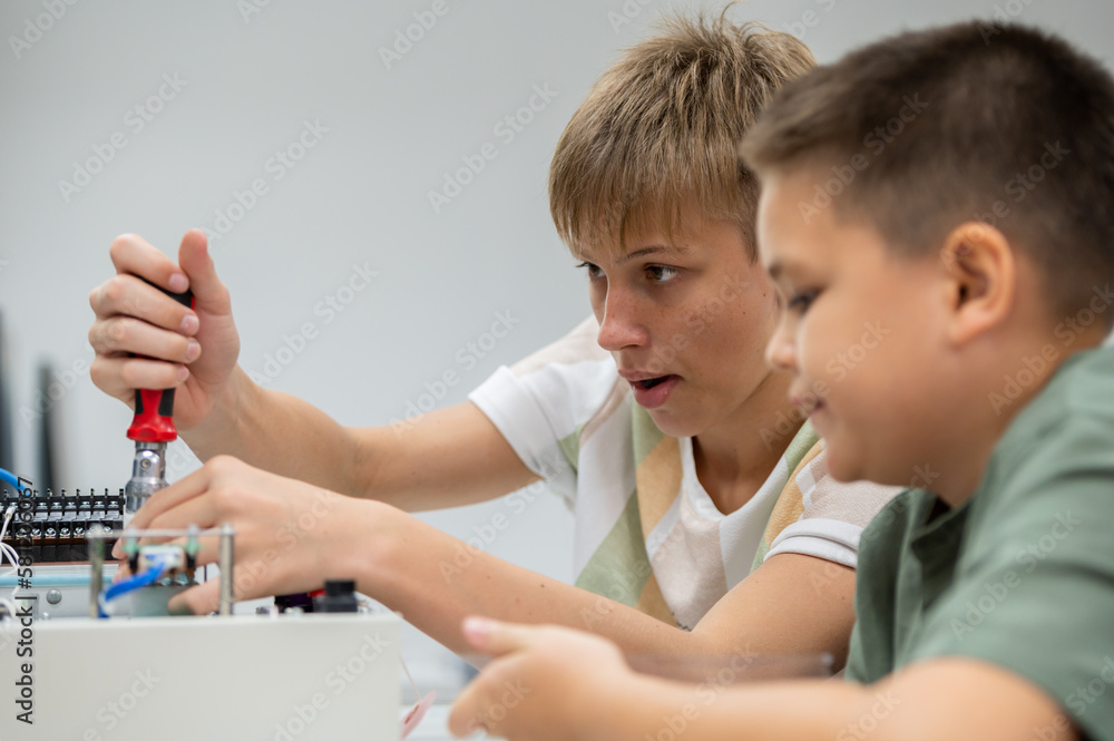 Group Kid teen child enjoy Machine Learning Robot arm is Moving Under coding Control robot at stem technology class, stem education for digital automation learn for use artificial intelligence ai Group Kid teen child enjoy Machine Learning Robot arm is Moving Under coding Control robot at stem technology class, stem education for digital automation learn for use artificial intelligence ai