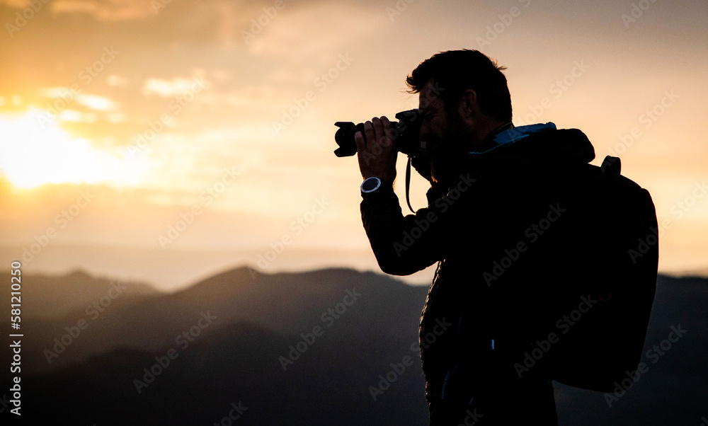 male photographer in nature at sunset male photographer in nature at sunset