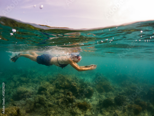 woman snorkeling in clear tropical sea