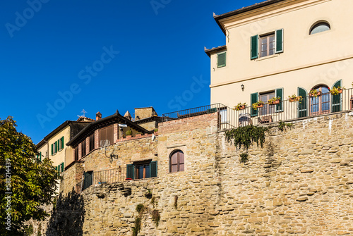 Cortona  Italy. Fragment of the ancient city fortress wall  rebuilt into a residential building