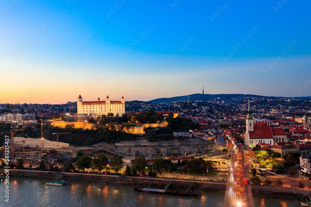 View of Bratislava castle, old town and the Danube river from observation deck the bridge in Bratislava, Slovakia at night