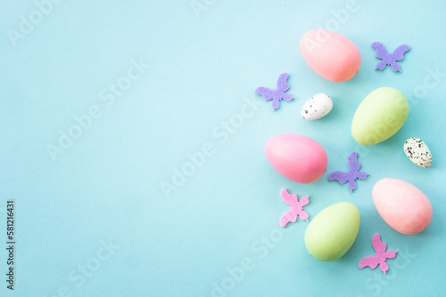 Easter eggs, holiday background on blue. Flat lay with copy space.