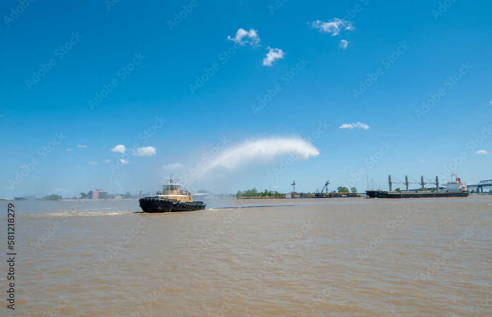 Cityscape of New Orleans with Mississippi river. Boat Pouring Water during the French Quarter Festival. Louisiana