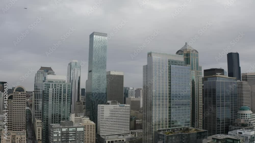 Revealing panoramic view of downtown Seattle, Washington USA with Puget Sound harbor and pier and plane flying over - 4K Drone Revealing panoramic view of downtown Seattle, Washington USA with Puget Sound harbor and pier and plane flying over - 4K Drone