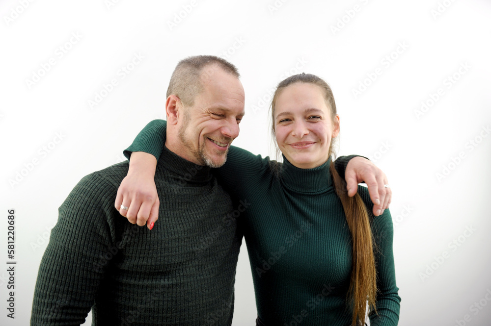 two friends man and a woman hugged standing laughing smiling on a white background green sweaters throwing a hand on their shoulder having fun team colleagues business two friends man and a woman hugged standing laughing smiling on a white background green sweaters throwing a hand on their shoulder having fun team colleagues business