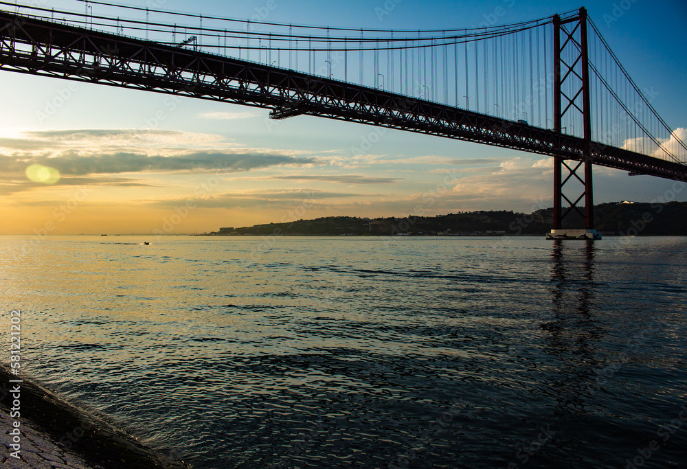 Suspension bridge in the city of Lisbon. Huge metal structure