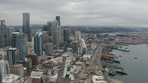Aerial skyline view of downtown Seattle with piers of The Great Wheel and Puget Sound harbor - 4K Drone