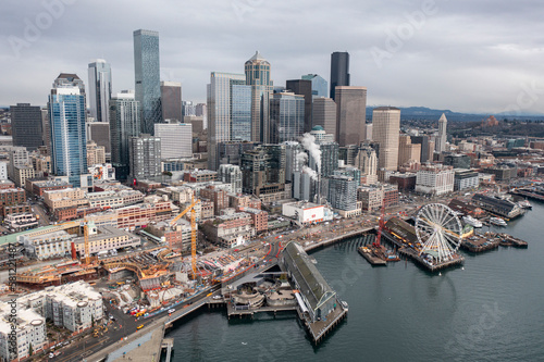Seattle  Washington USA - February 28 2023  Aerial drone view of Seattle skyline cityscape with The Great Wheel  Pike Place Market  and harbor piers along Puget Sound