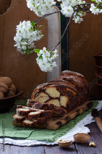 Obraz na płótnie Traditional Easter bread with chocolate and nut filling on a wooden background. w salonie