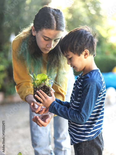 Girl and boy planting vegetables in the garden