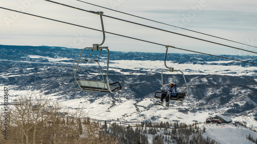 Skier on ski lift in Steamboat Springs, Colorado ski resort landscape