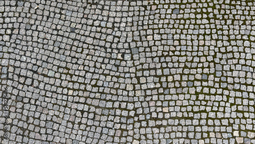 Φωτογραφία Texture of dark gray granite street paving stones with moss in the seams