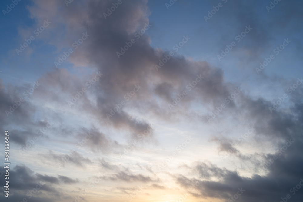 Cloudscape at golden hour with blue sky and warm clouds