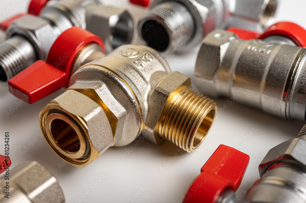 brass, metal water faucets with red valve, different, isolated on light background close-up, plumbing connection brass, metal water faucets with red valve, different, isolated on light background close-up, plumbing connection