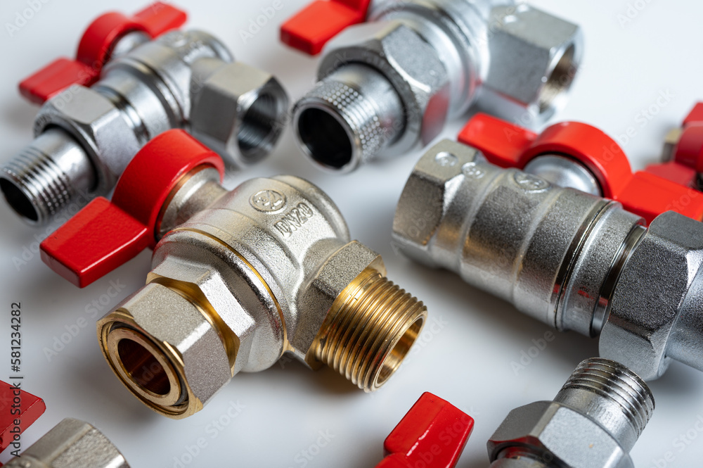 brass, metal water faucets with red valve, different, isolated on light background close-up, plumbing connection brass, metal water faucets with red valve, different, isolated on light background close-up, plumbing connection