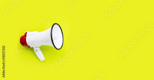 Red and white megaphone on green background.