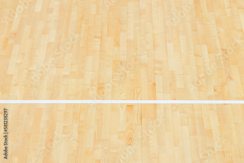 Wooden floor volleyball, basketball, badminton, futsal, handball court with light effect. Wooden floor of sports hall with marking lines line on wooden floor indoor, gym court © Augustas Cetkauskas