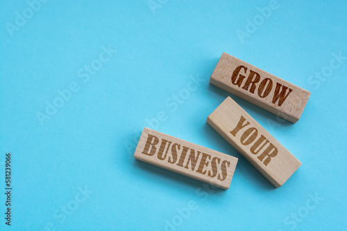 GROW YOUR BUSINESS - words from wooden blocks with letters, Business concept