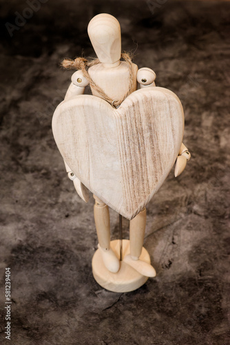 Wooden figures with handmade wooden carved heart with space for text.
