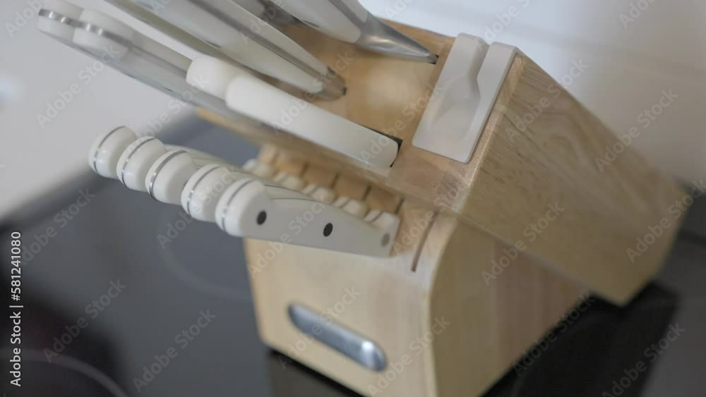 This close up video shows a hand pulling a knife out of a kitchen cutlery block. This close up video shows a hand pulling a knife out of a kitchen cutlery block.
